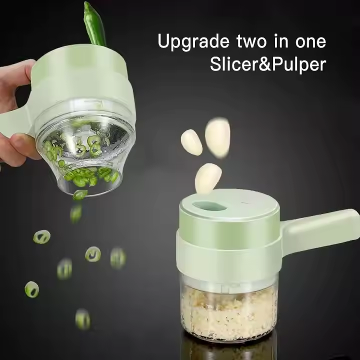 A light green electric food slicer and pulper shown in use against a dark background, with a hand holding the upper cutting chamber and garlic cloves and chopped green onions floating around to demonstrate slicing and pulping. Text on the image reads 'Upgrade two in one Slicer&Pulper'.