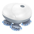 White and gray scalp massager with blue lights on a white background